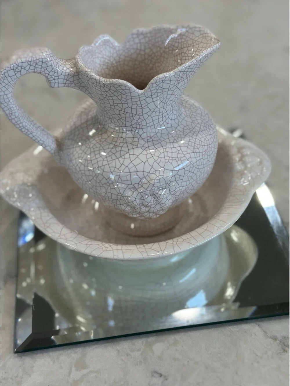 Farmhouse-style pitcher and basin set, featuring a distinct white crackle finish